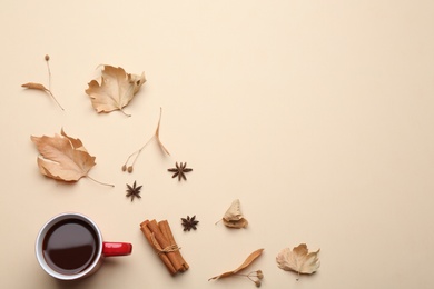 Photo of Flat lay composition with hot drink on beige background, space for text. Cozy autumn