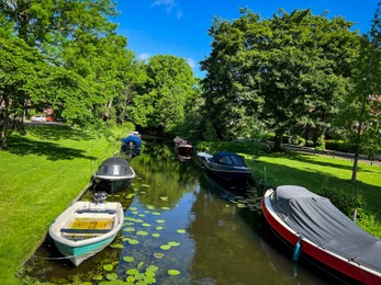 Photo of Beautiful view of canal with moored boats on sunny day