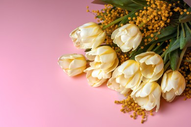 Photo of Bouquet with beautiful tulips and mimosa flowers on pink background. Space for text