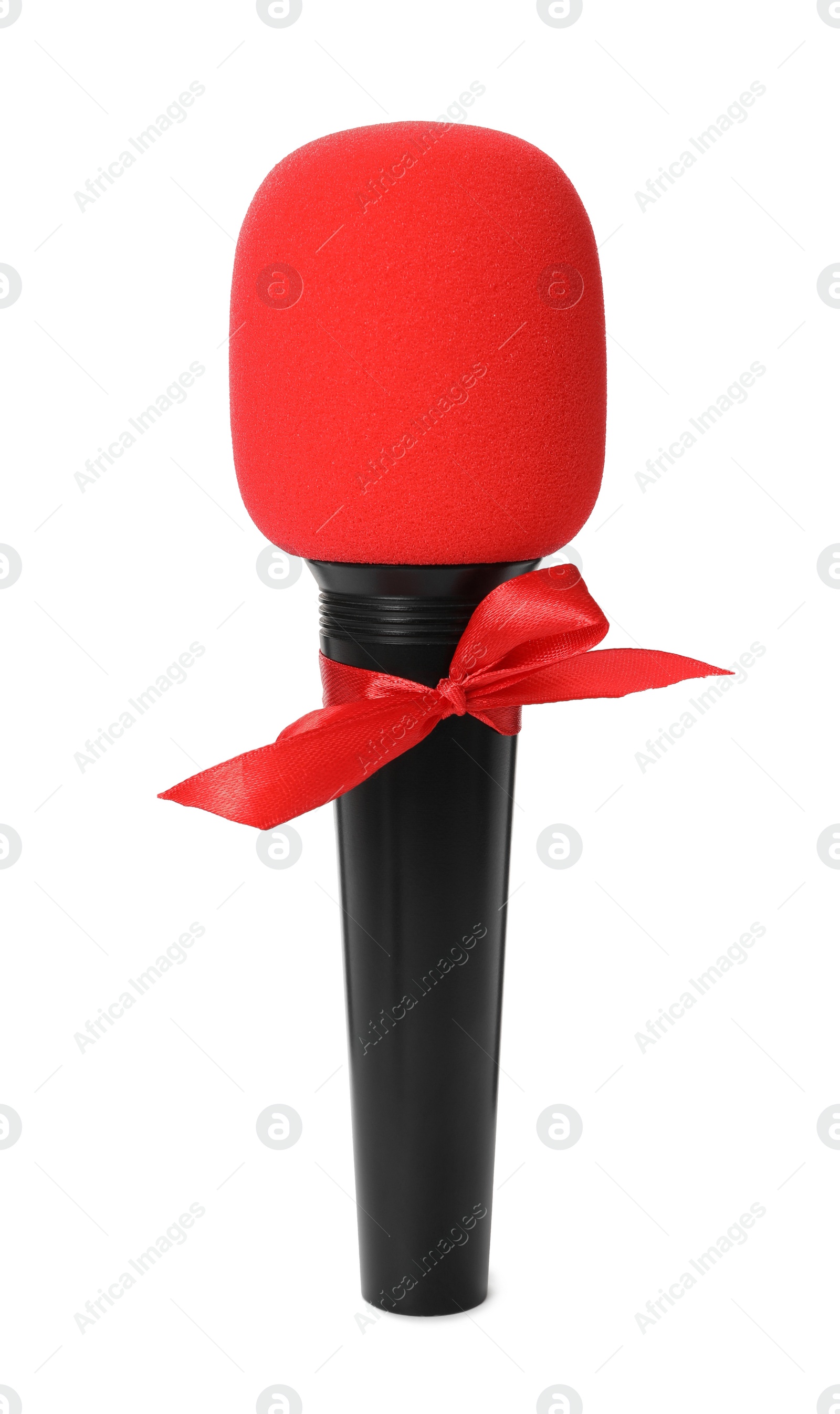 Photo of Microphone with red bow isolated on white. Christmas music