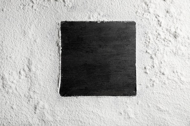Photo of Square frame made of flour on gray background, top view. Space for text