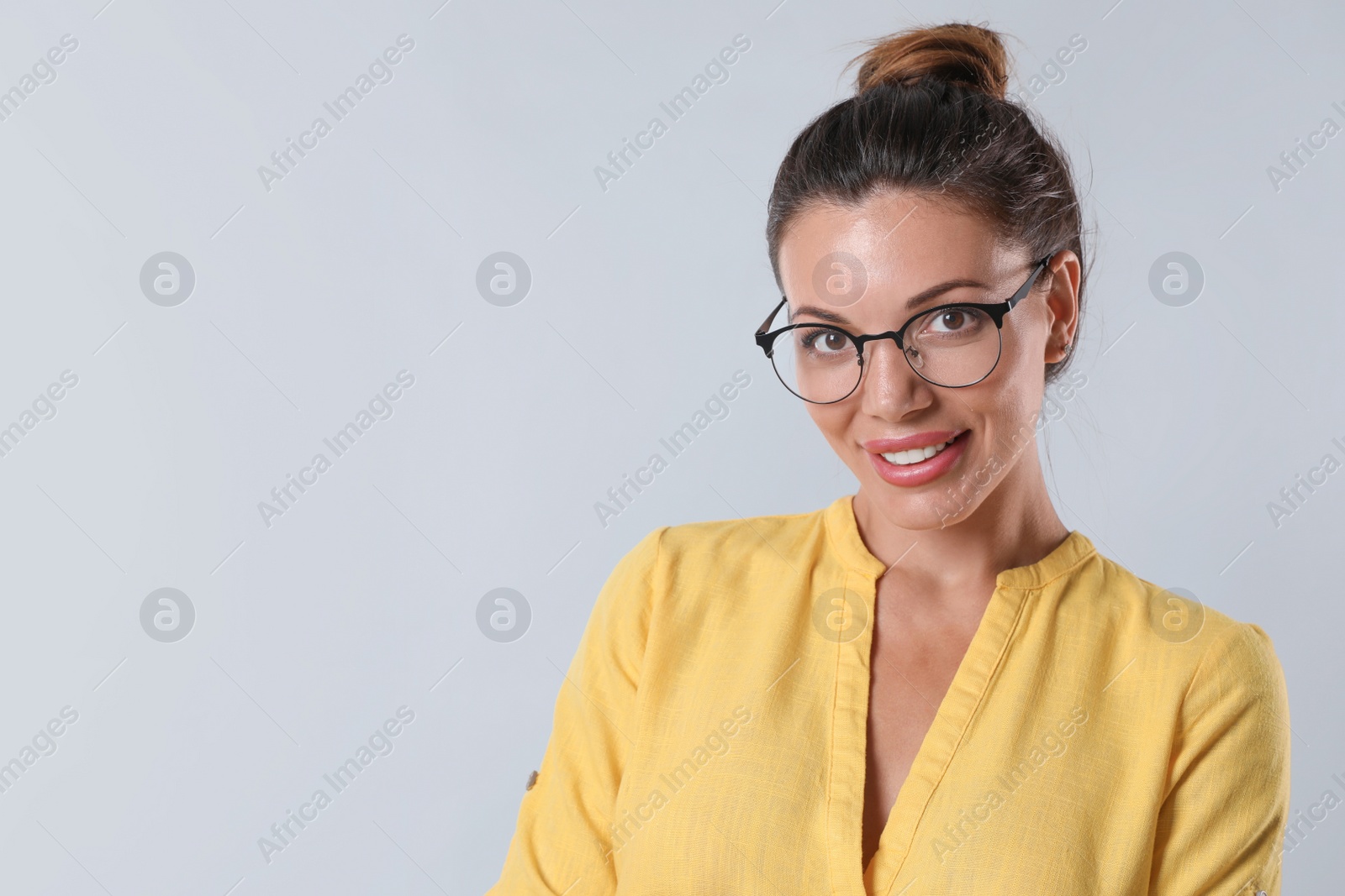 Photo of Beautiful woman in eyeglasses on white background, space for text