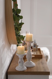 Photo of Modern room interior with chest of drawers near white wall