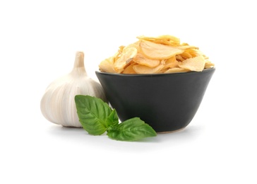 Photo of Bowl of dried garlic flakes and basil on white background