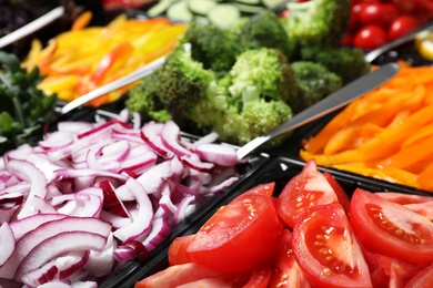 Photo of Salad bar with different fresh ingredients as background, closeup