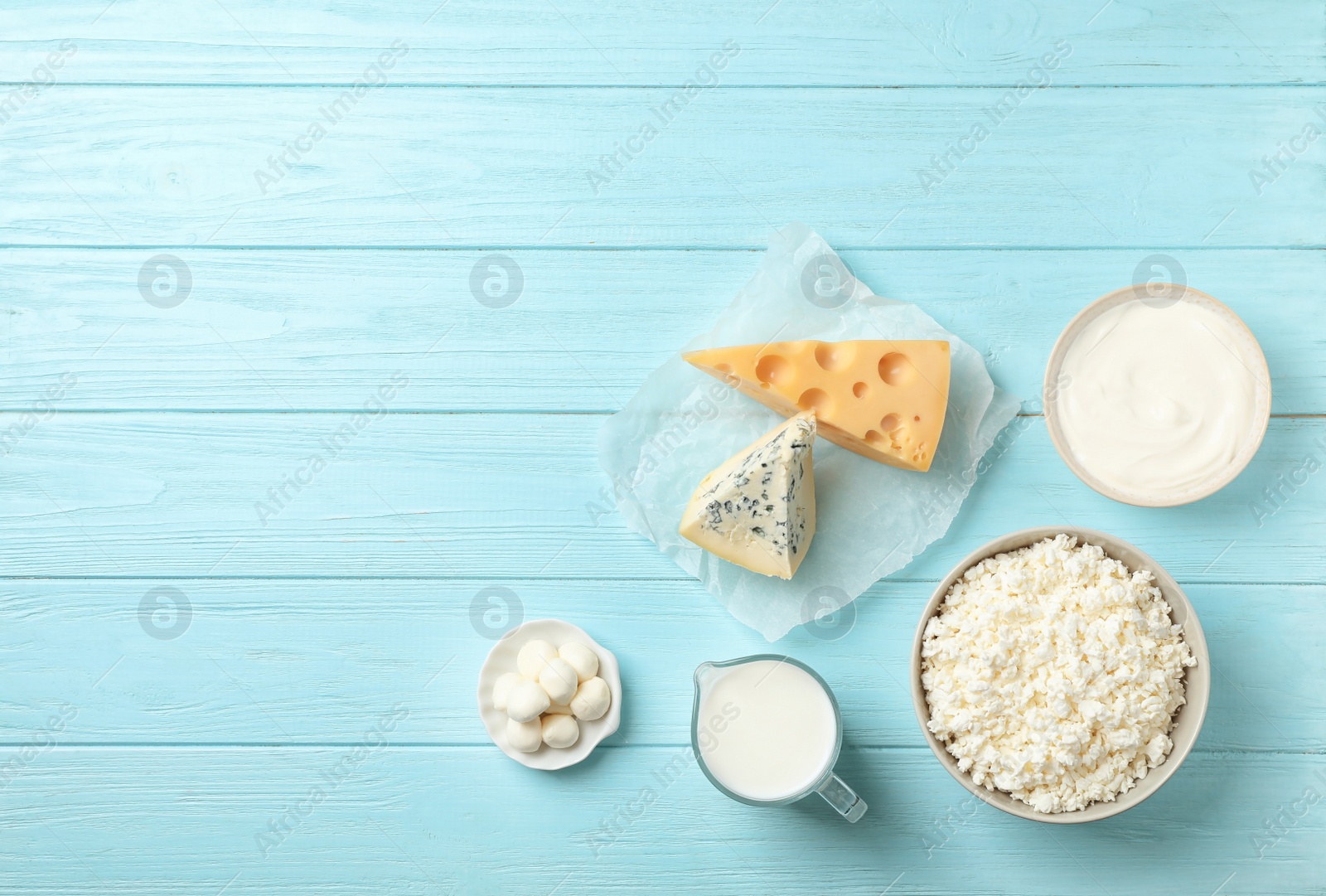Photo of Flat lay composition with different dairy products on wooden background