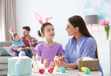 Photo of Happy family preparing for Easter holiday at home