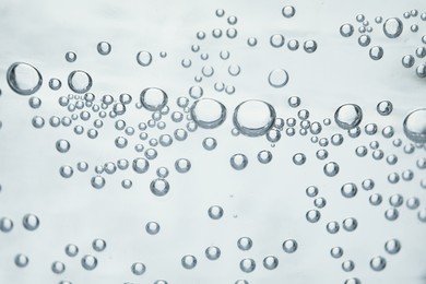 Photo of Soda water with bubbles of gas, closeup