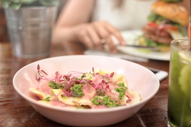 Photo of Plate with tasty fresh dumplings on table