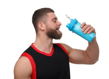 Young man with muscular body holding shaker of protein on white background