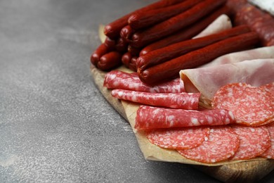 Different types of sausages on brown table, space for text