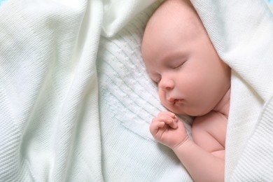 Photo of Cute newborn baby sleeping on white blanket, top view. Space for text