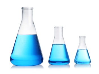 Photo of Conical flasks with blue liquid on white background. Laboratory glassware