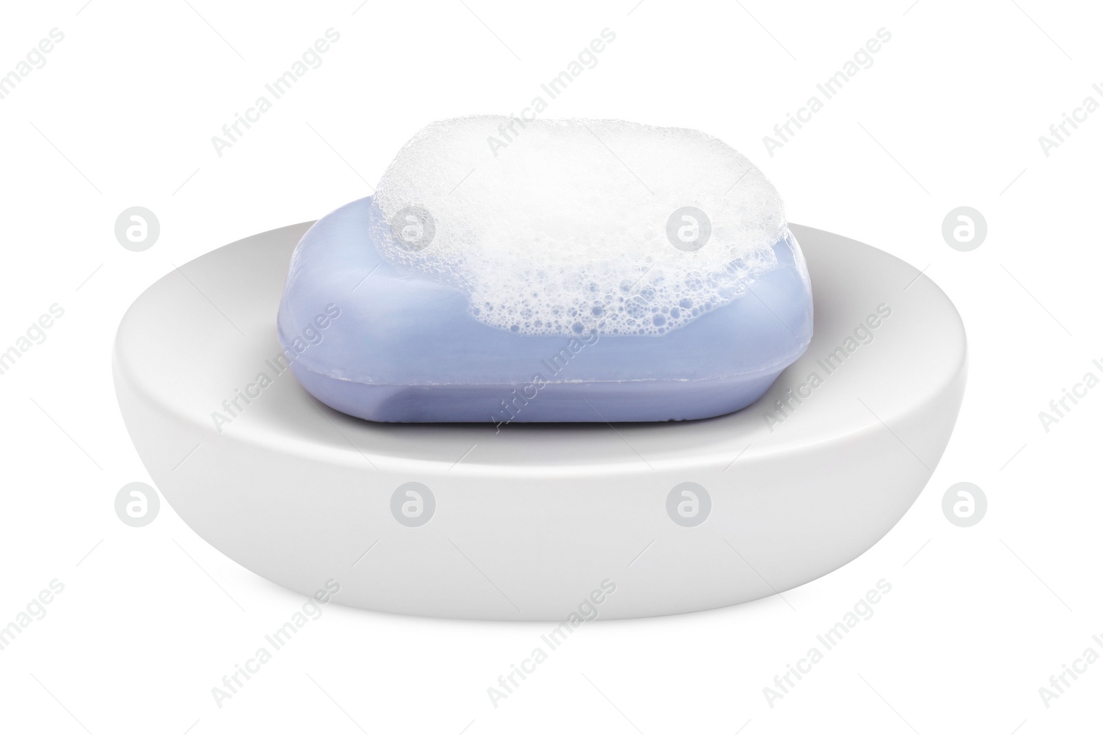 Photo of Soap bar with fluffy foam in holder on white background