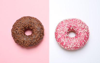 Delicious glazed donuts on color background, flat lay