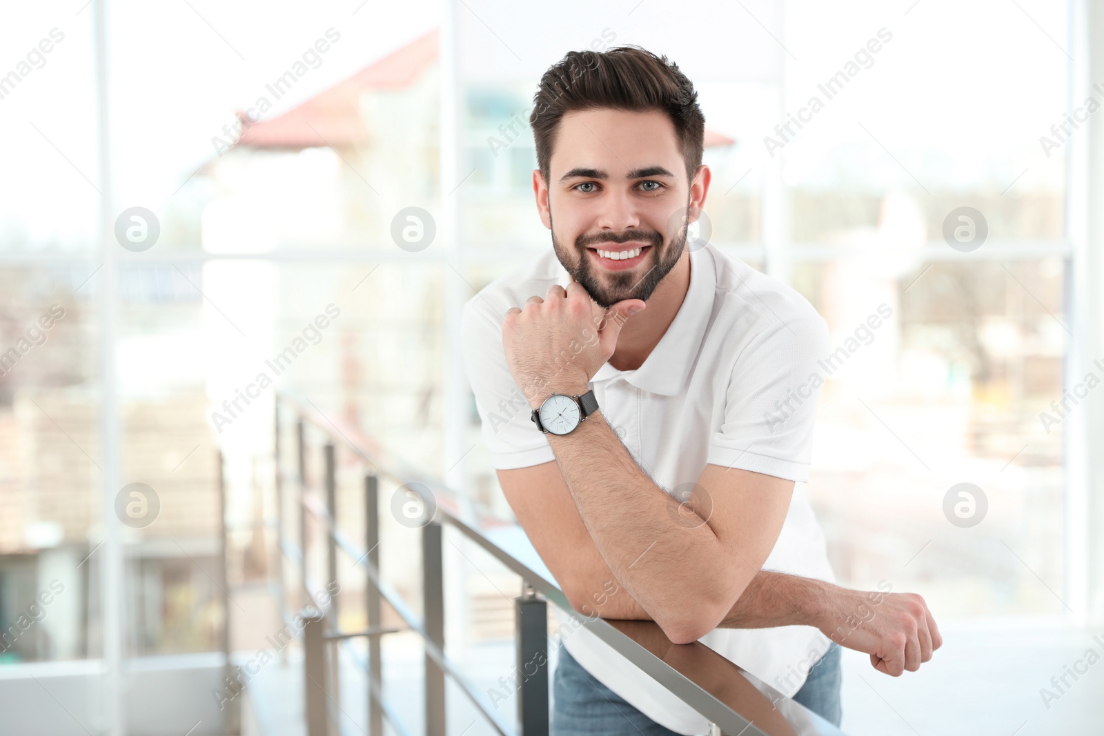 Photo of Portrait of handsome man smiling in light room