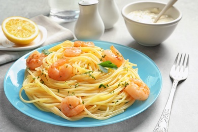 Photo of Plate with spaghetti and shrimps on table