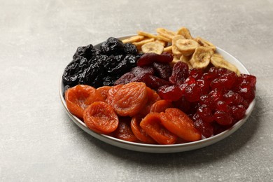 Photo of Delicious dried fruits on grey table, closeup