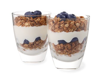Photo of Glasses of tasty yogurt with muesli and blueberries isolated on white