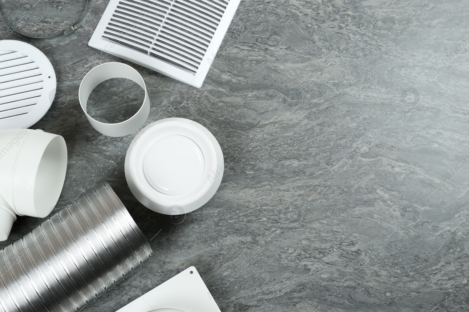 Photo of Parts of home ventilation system on grey stone surface, flat lay. Space for text