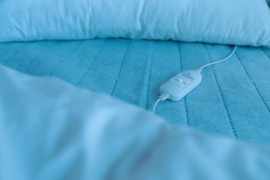 Photo of Bed with electric heating pad, closeup view