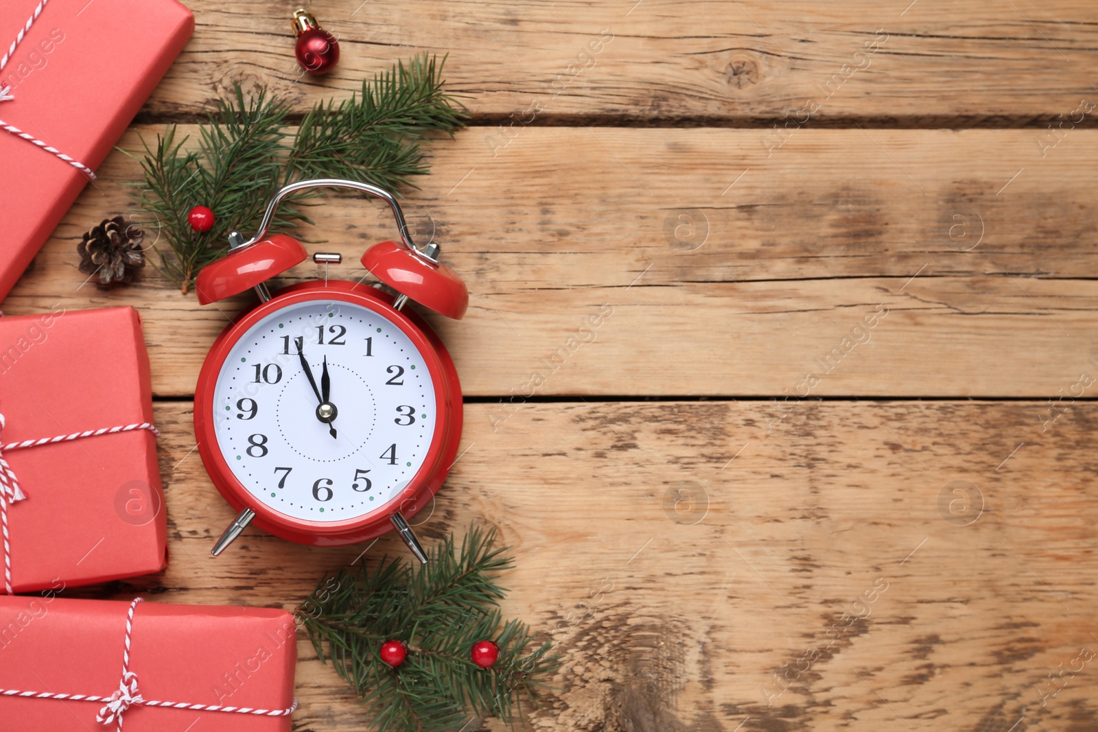 Photo of Flat lay composition with Christmas gifts and alarm clock on wooden table, space for text. Boxing day