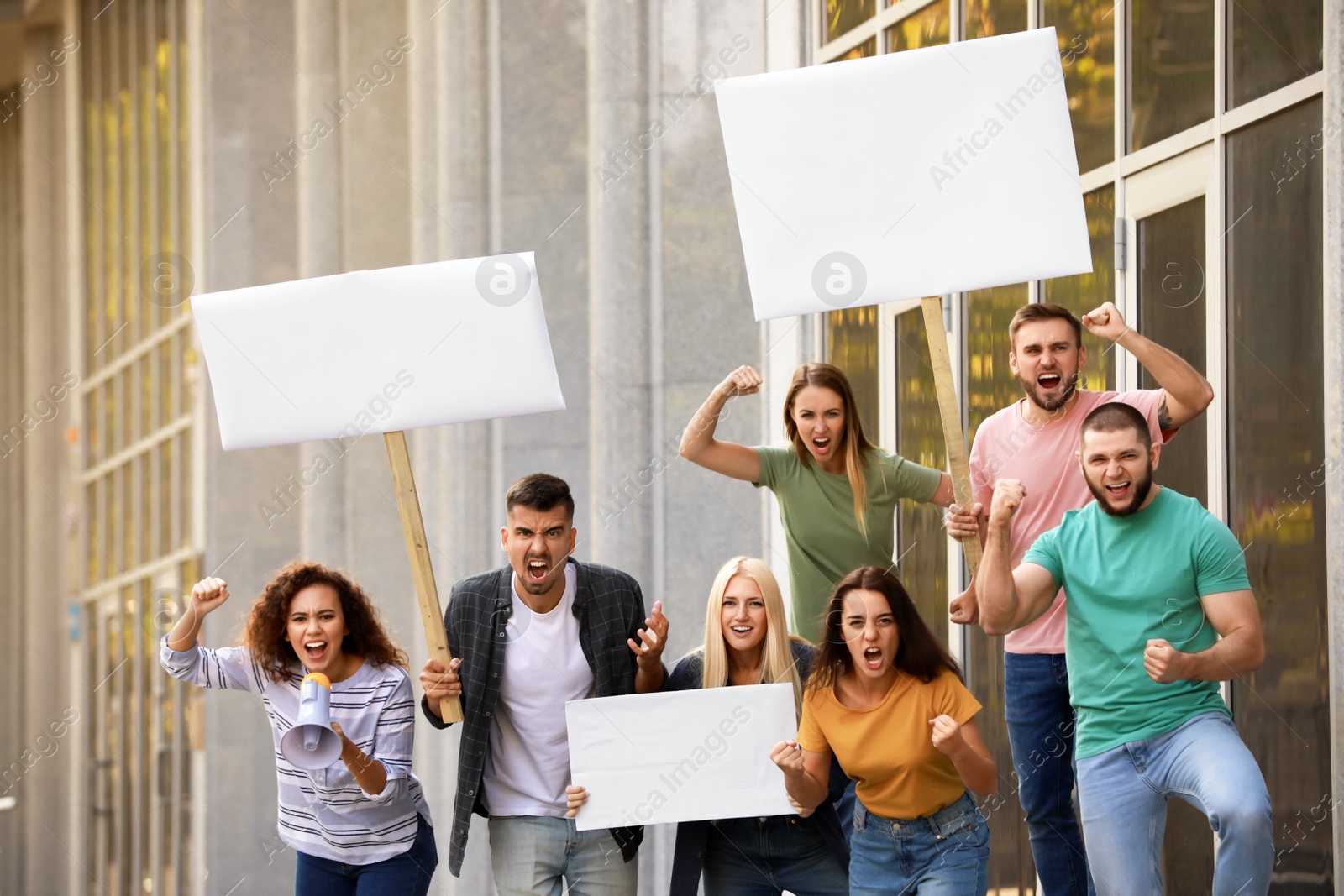 Photo of Angry African-American woman with megaphone leading protest outdoors