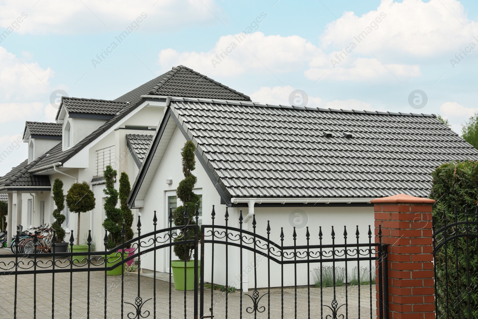 Photo of Modern buildings with grey roofs in forest on spring day