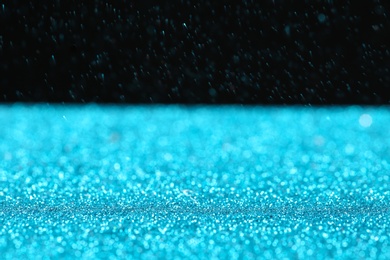 Photo of Glitter on table against dark background, space for text. Bokeh effect