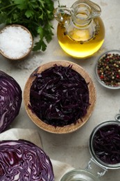 Tasty red cabbage sauerkraut and different ingredients on table, flat lay