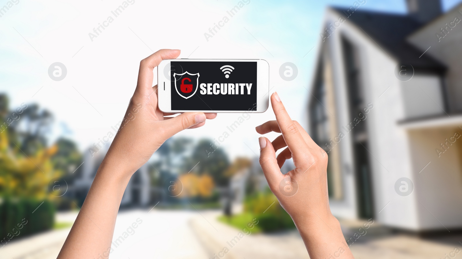 Image of Alarm system. Woman using phone outdoors, closeup