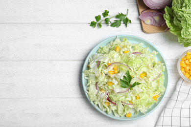 Photo of Fresh napa cabbage salad served on white wooden table, flat lay. Space for text