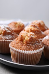 Delicious sweet muffins on grey table, closeup. Space for text