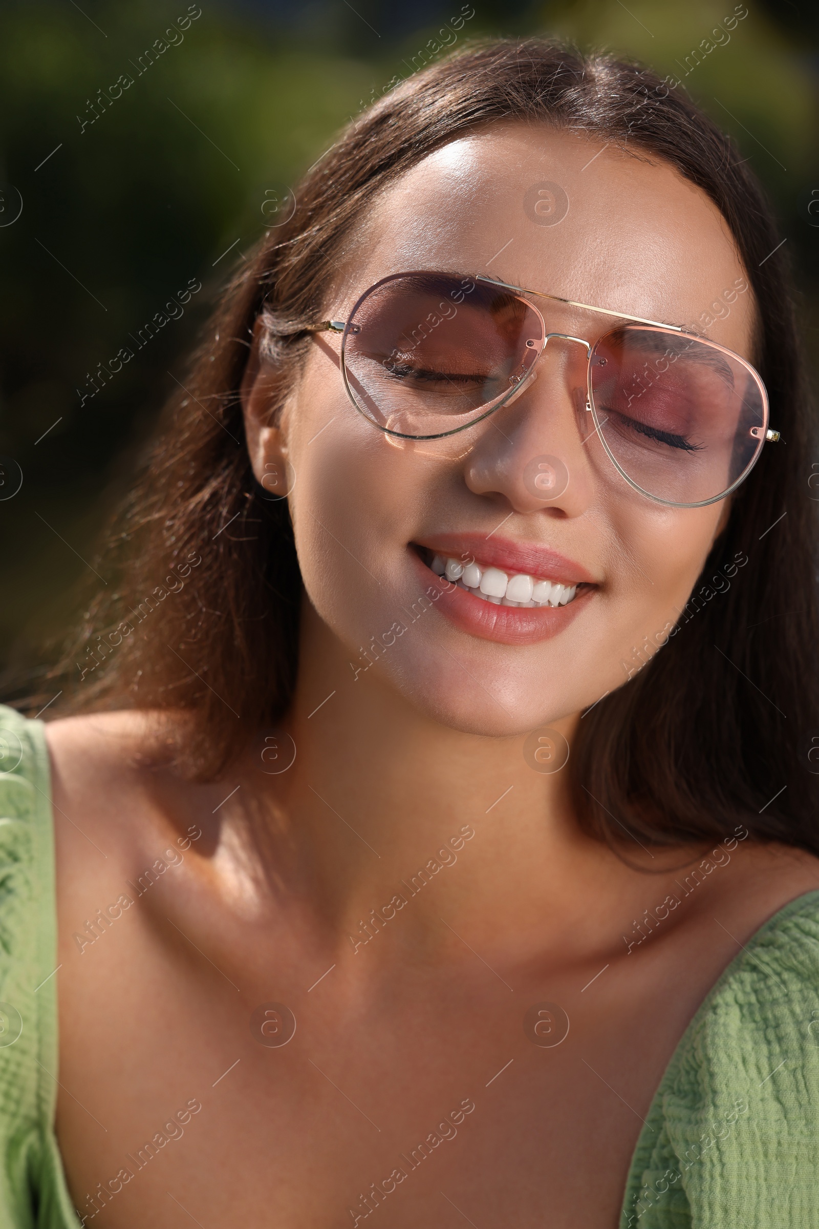 Photo of Beautiful woman in sunglasses outdoors on sunny day