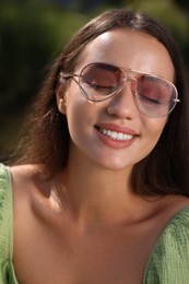 Beautiful woman in sunglasses outdoors on sunny day