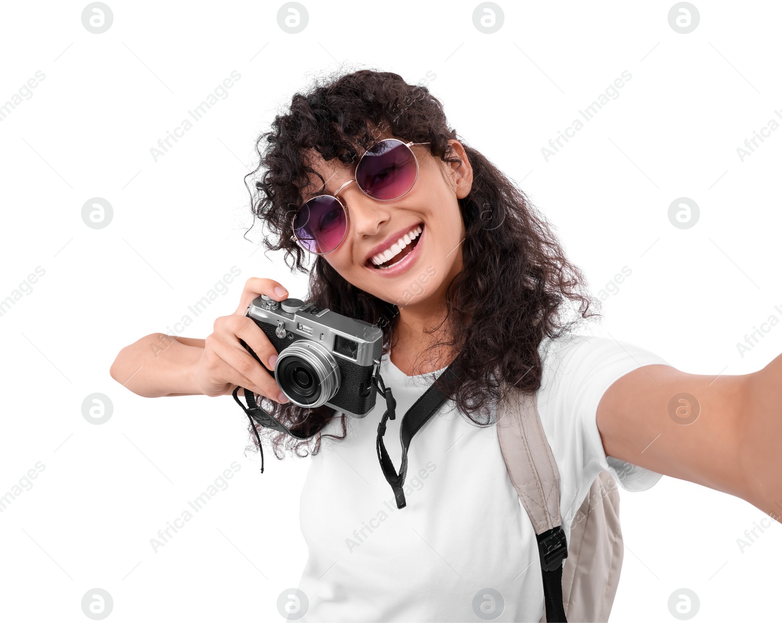 Photo of Beautiful woman in sunglasses with camera taking selfie on white background