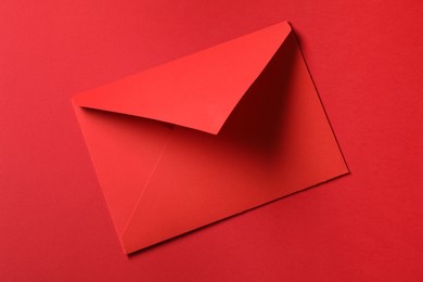 Photo of Letter envelope on red background, top view