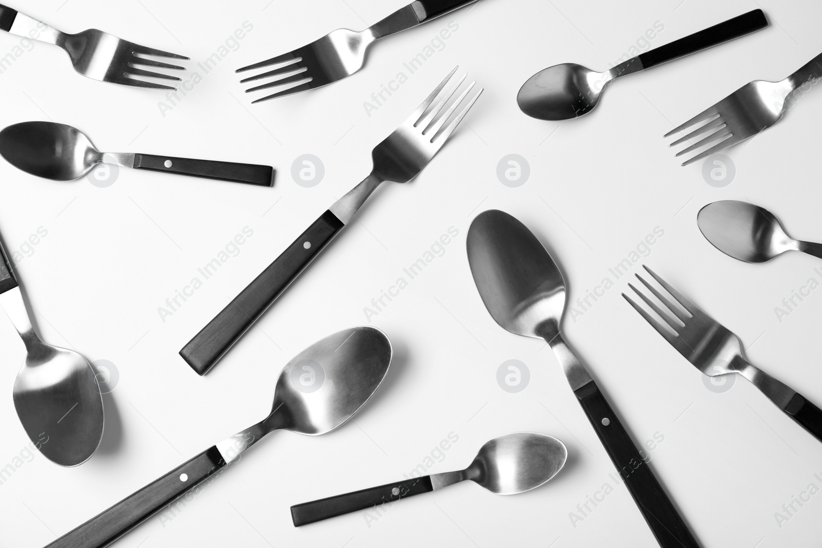 Photo of Set of new metal cutlery on white background, top view