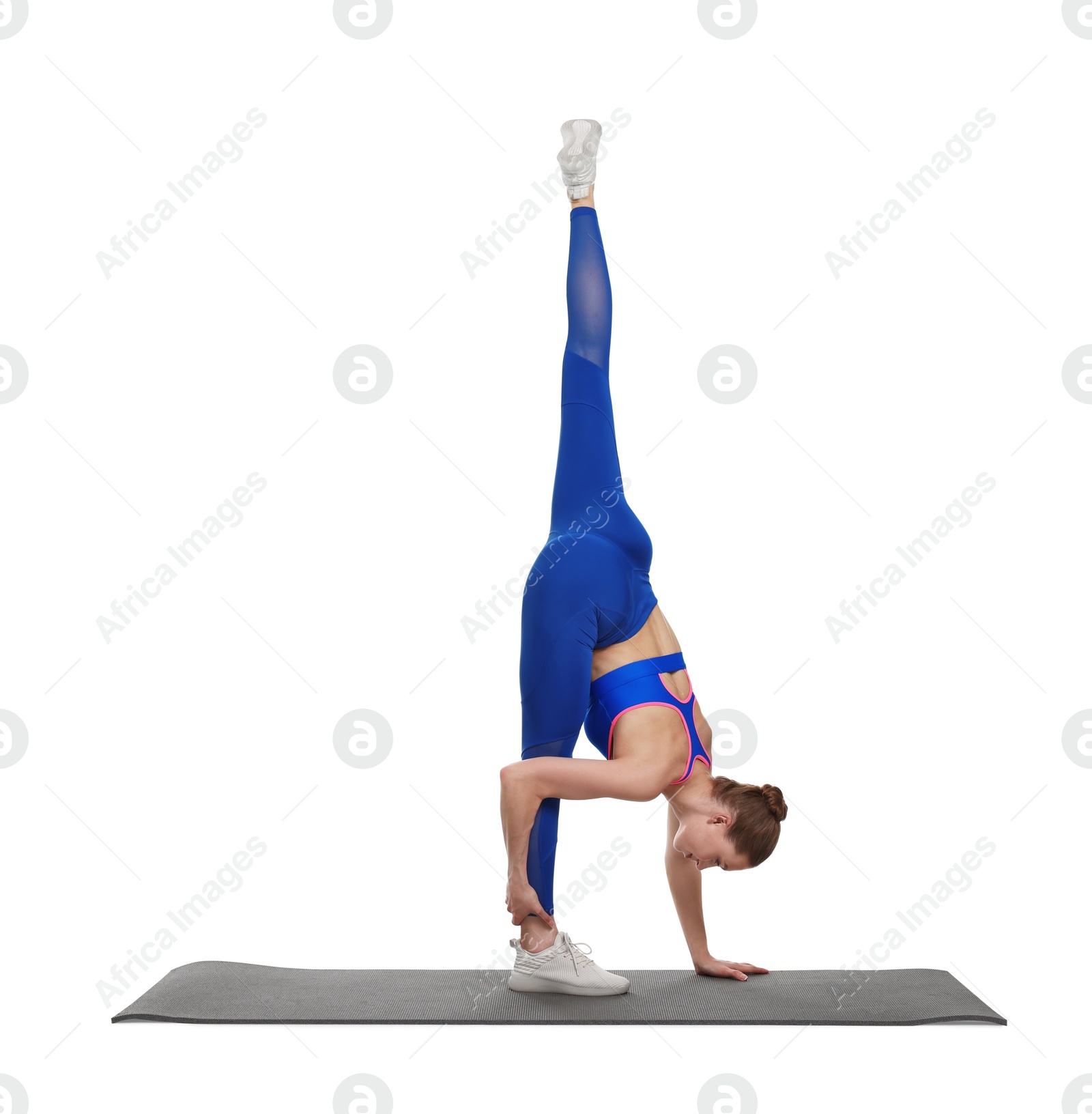 Photo of Yoga workout. Young woman stretching on white background