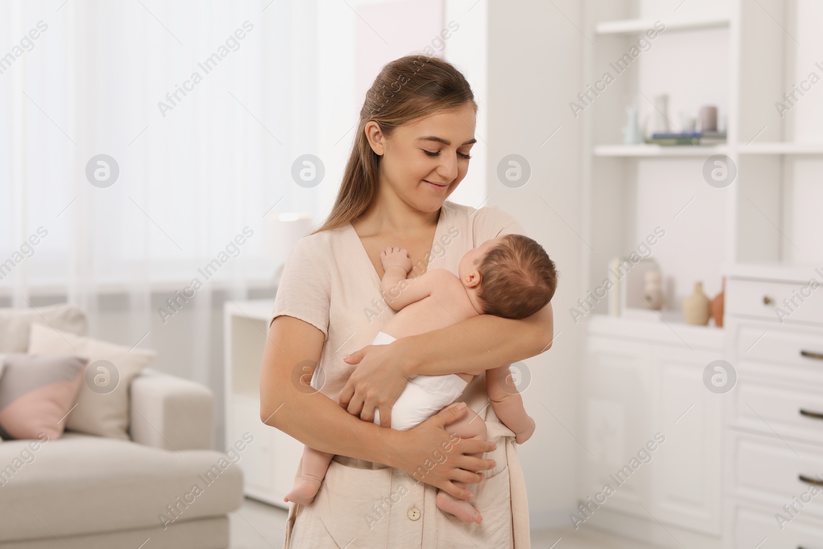 Photo of Mother holding her cute newborn baby at home