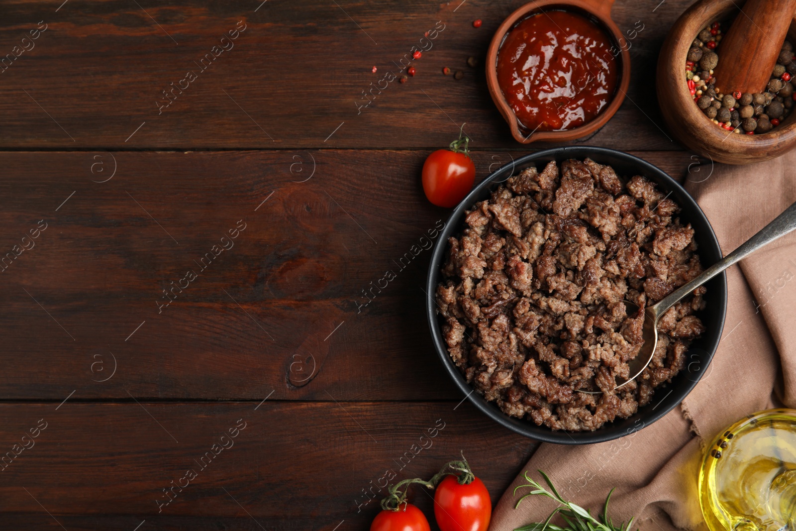 Photo of Fried minced meat and different products on wooden table, flat lay. Space for text