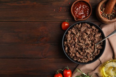 Photo of Fried minced meat and different products on wooden table, flat lay. Space for text