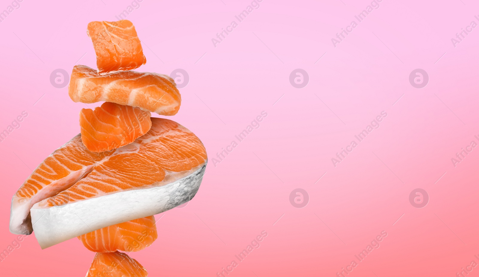 Image of Cut fresh salmon falling on pink gradient background, space for text