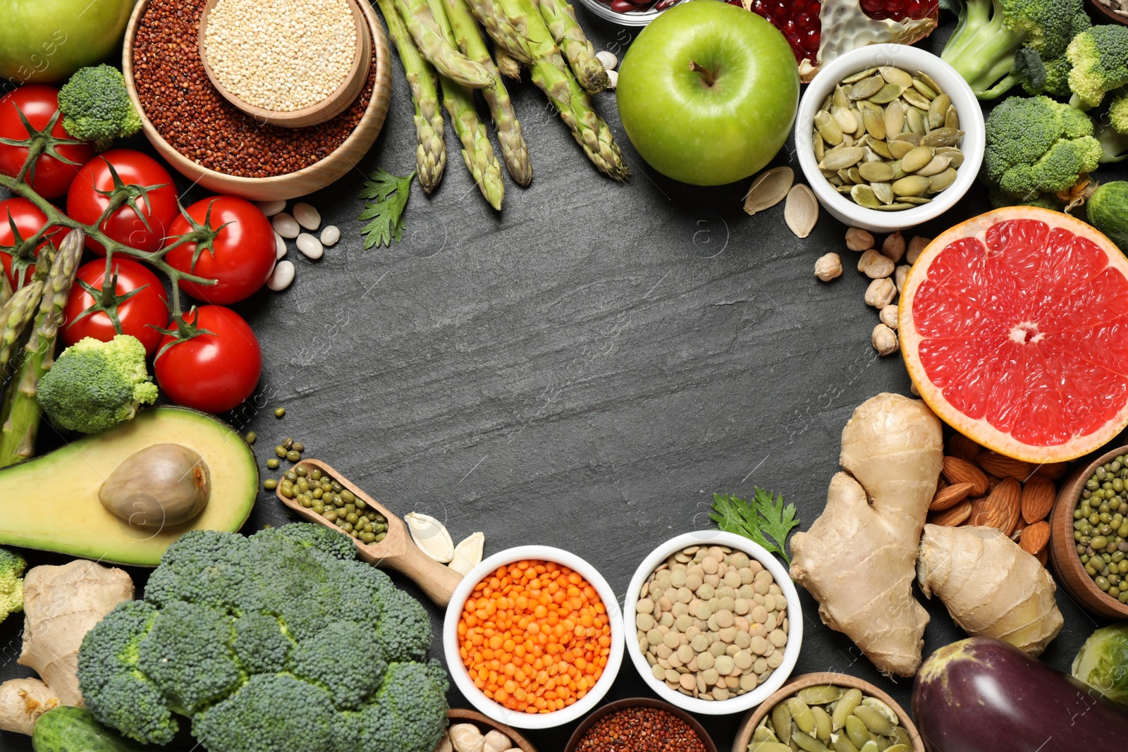 Photo of Frame of fresh vegetables, fruits and seeds on black table, flat lay. Space for text