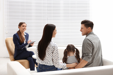 Photo of Professional psychologist working with family in office