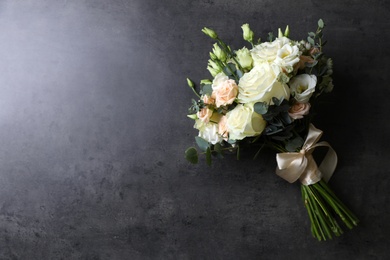 Photo of Beautiful wedding bouquet on grey stone table, top view. Space for text