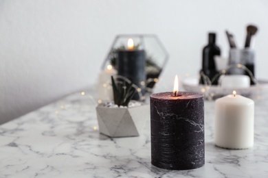 Photo of Burning candles on marble table, space for text