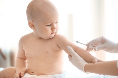 Doctor vaccinating baby in clinic