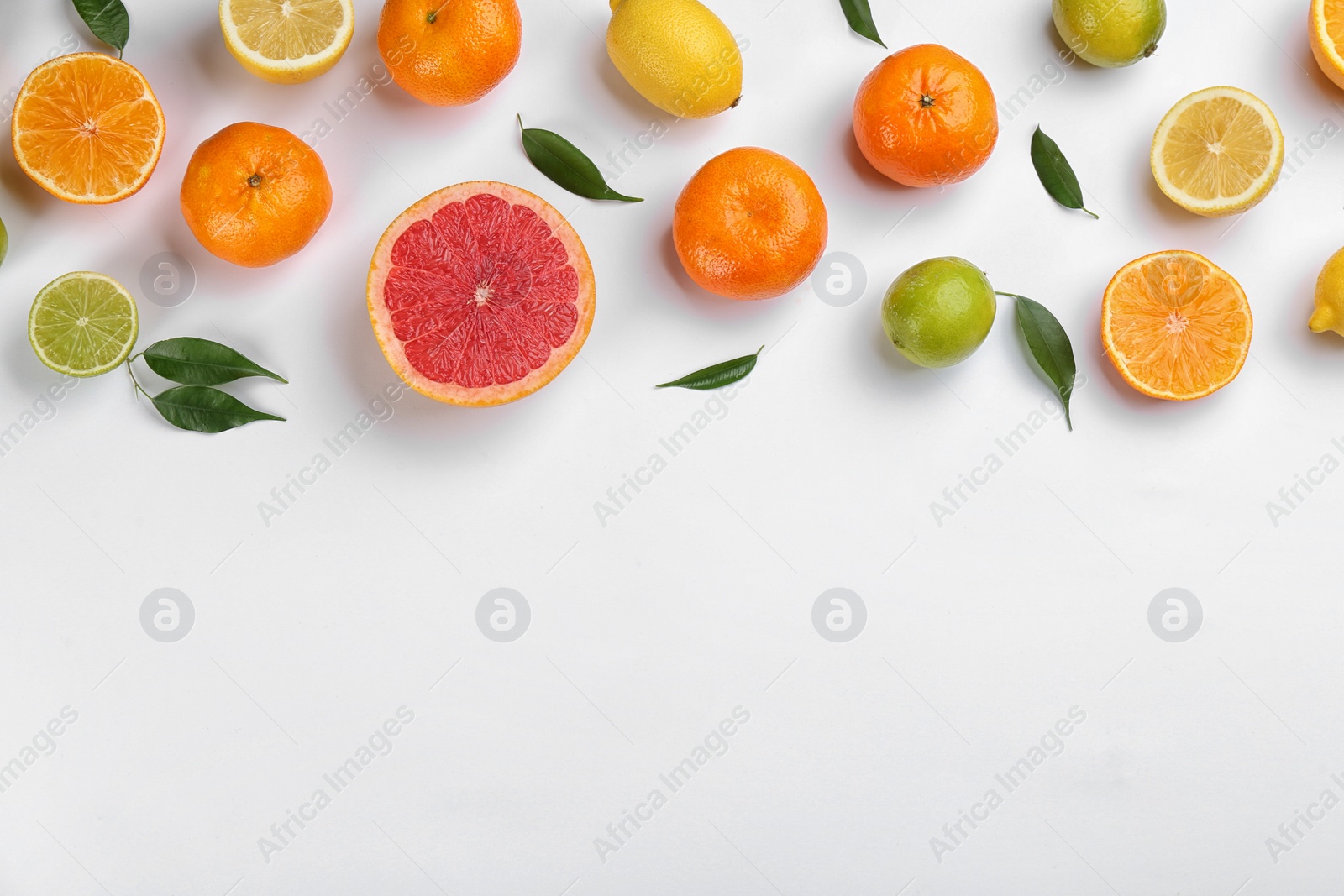 Photo of Flat lay composition with tangerines and different citrus fruits on white background. Space for text