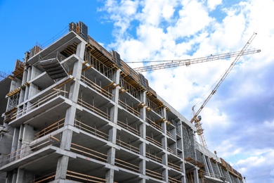 Unfinished building against blue sky. Construction safety rules